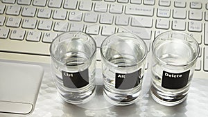 Computer or laptop keyboard with Ã¢â¬ÅCtr-Alt-DeleteÃ¢â¬Â command which pictured on three glasses photo